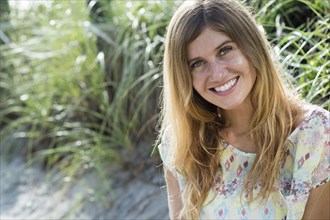 Caucasian woman smiling on beach