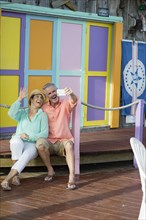 Older Caucasian couple taking selfie