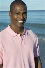 Portrait of smiling Black man on beach
