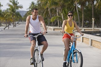 Hispanic couple riding bicycles