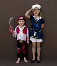 Caucasian children playing dress up
