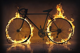Silhouette of bicycle with flaming tires