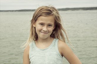 Caucasian girl smiling near lake