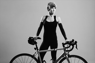 Caucasian athlete standing with bicycle