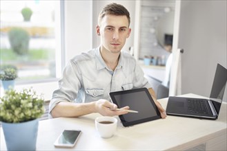 Caucasian man showing digital tablet