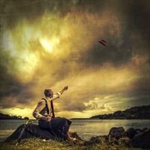 Caucasian man flying derby kite near remote lake