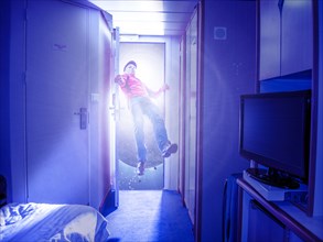 Caucasian man flying in bedroom