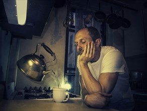 Caucasian man pouring cup from levitating tea kettle