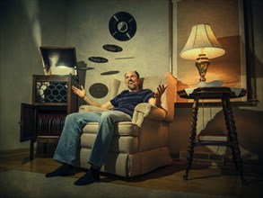 Caucasian man levitating records in living room