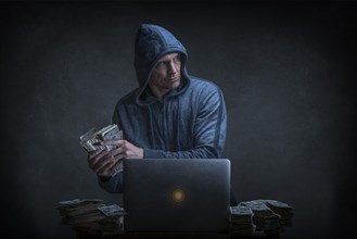 Caucasian hacker stealing money from laptop