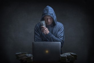 Caucasian hacker stealing money from laptop