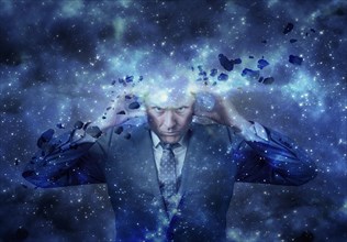 Head of businessman exploding in outer space