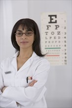 Female doctor in front of eye chart