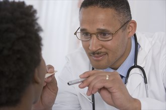 African doctor examining patient