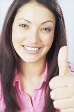 Young woman giving thumbs up