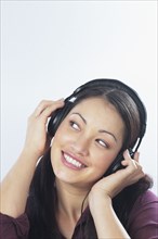 Young woman listening to headphones