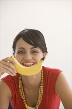 Young woman holding banana