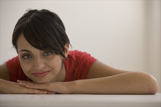 Young woman resting chin on hands