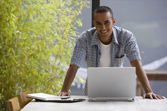 Portrait of young man with laptop