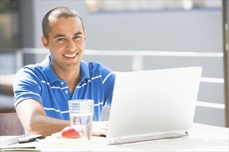 Young man typing on laptop