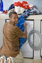 Young man doing laundry