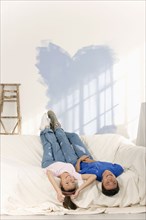 Asian couple in partially painted room