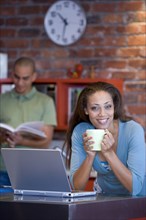 African American woman holding coffee mug