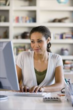 African American woman typing on computer