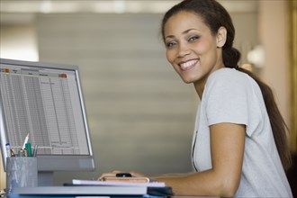 African American woman typing on computer