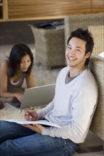 Asian couple working at home