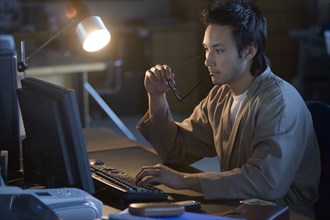 Asian businessman typing on computer