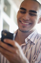 African American man looking at cell phone