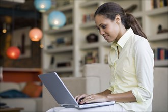 African American woman typing on laptop