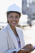 African American businesswoman wearing hardhat