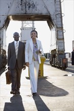 African American businesspeople walking on commercial pier