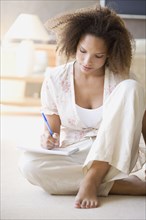 African woman writing on note pad