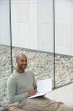 African man writing in notepad