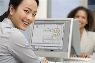 Asian businesswoman typing on computer