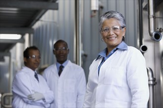 African scientists standing in factory