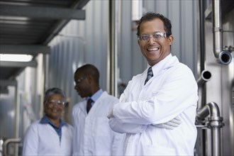 African scientists standing in factory