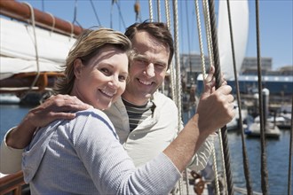 Caucasian couple smiling on sailboat