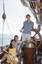Caucasian friends relaxing on sailboat