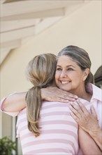 Caucasian mother and daughter hugging