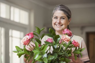 Caucasian woman arranging flowers