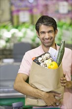 Caucasian man buying groceries