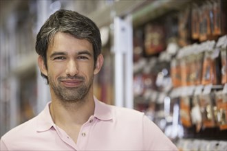 Caucasian man smiling in hardware store