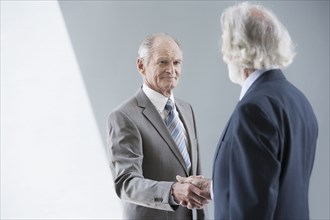 Senior Caucasian businessmen shaking hands