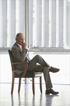 Senior Caucasian businessman sitting in chair