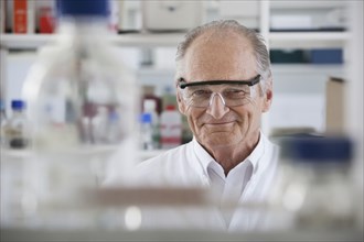 Senior Caucasian scientist smiling in lab