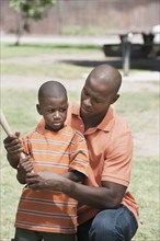 Father teaching son to play baseball
